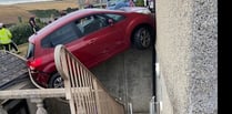 Rescue operation after car left hanging precariously over courtyard