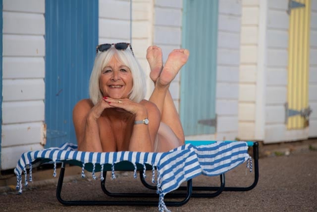 Mermaid Stella takes a break by the beach huts