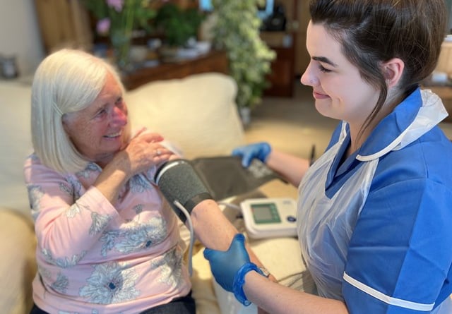 A nurse visiting a patient in her own home