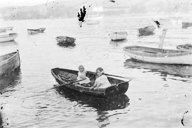 Photograph of two small children in a rowing boat - taken from a glass plate 