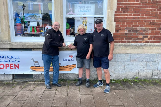 Club chairman Mike Felton and competition organiser Mike Johnson hand over a cheque to Dart RNLI acting fundraising committee chair John Butler