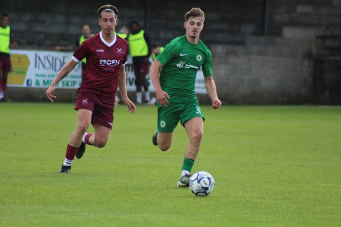 Ivybridge Town youngster Rio Daly with eyes on the ball against Paulton Rovers