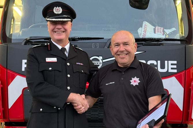 Assistant Chief Fire Officer Gerald Taylor presented the station’s Watch Manager Dave Harvey with The Fire and Rescue Service Long Service and Good Conduct Medal Thirty Years of Service Clasp