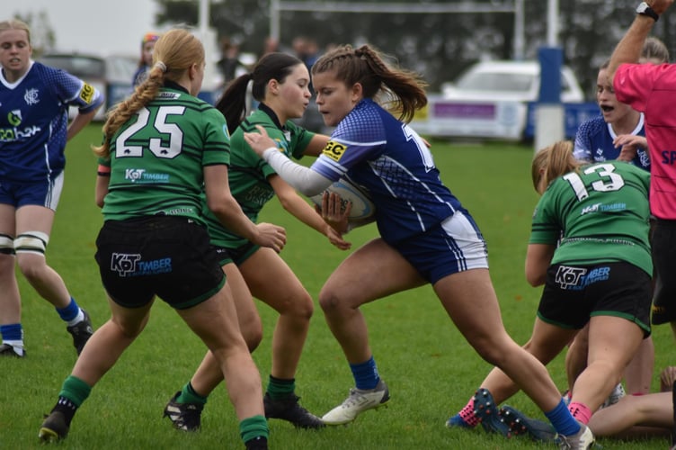 Fly-half Amelia Benfield (with the ball) helped Scarlett Murgatroyd with her second try 