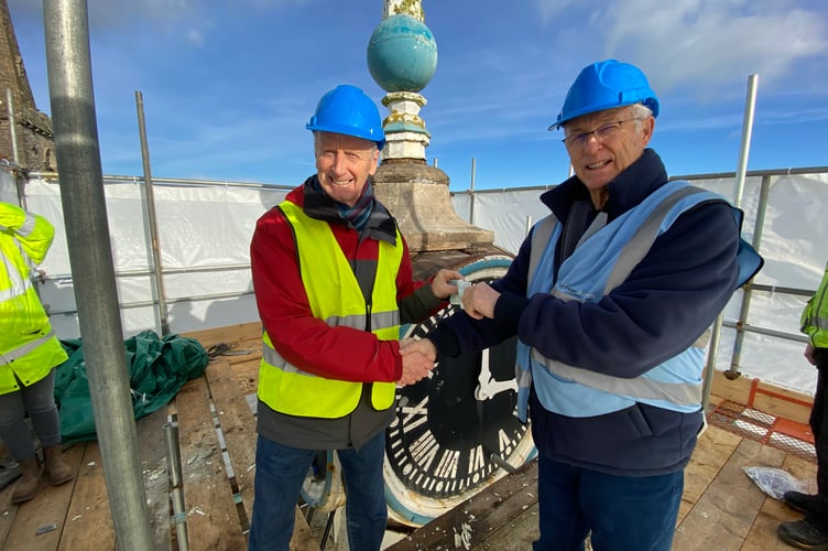 Chair John Donovan receiving a check from Robert Cattell 