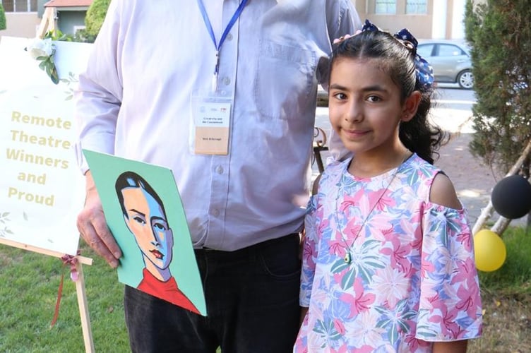 Mr Bilbrough with one of the children who took part in Hands Up's art and poetry exhibition, which was staged in Gaza 