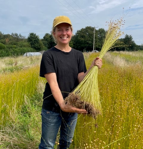 Zoe Gilbertson with harvested flax plant